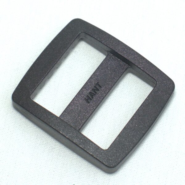 Plastic buckle for adjusting length of webbing or strap. Also known as an adjuster or square buckle or SB