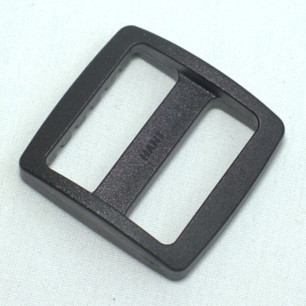 Plastic buckle for adjusting length of webbing or strap. Also known as an adjuster or square buckle or SB