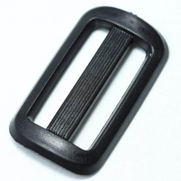 Plastic buckle for adjusting length of webbing or strap. Also known as an adjuster or square buckle or SB