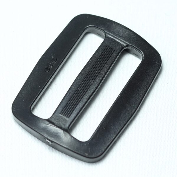 Plastic buckle for adjusting length of webbing or strap. Also known as an adjuster or square buckle or SB