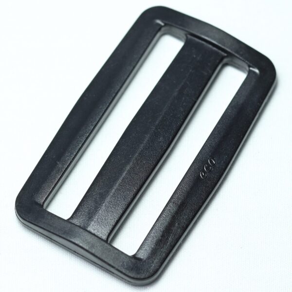 Plastic buckle for adjusting length of webbing or strap. Also known as an adjuster or square buckle or SB